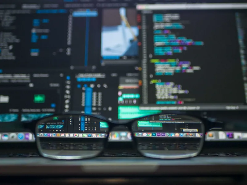 glasses sat on software developers laptop glasses sat on software developers laptop