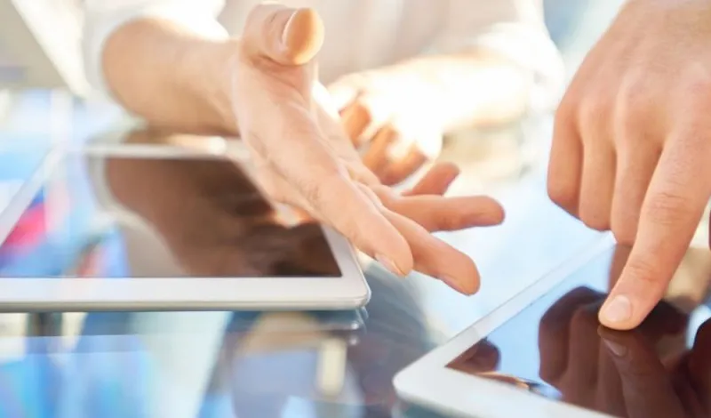 hand-pointing-at-tablet-and-smartphone