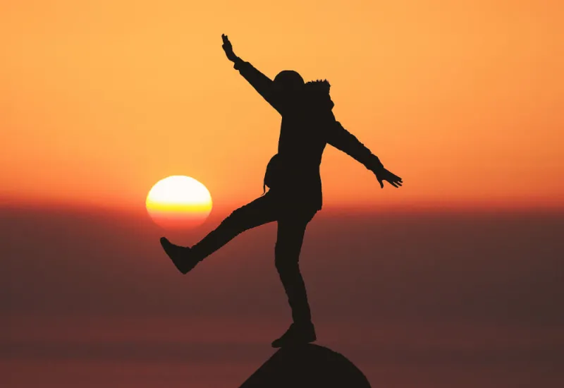 man-balancing-on-rock