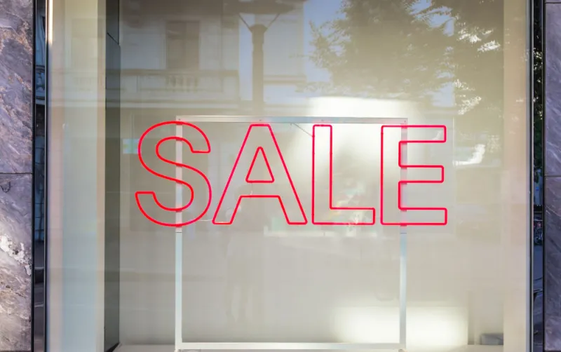 a-shop-window-with-a-sale-sign-in-red a-shop-window-with-a-sale-sign-in-red