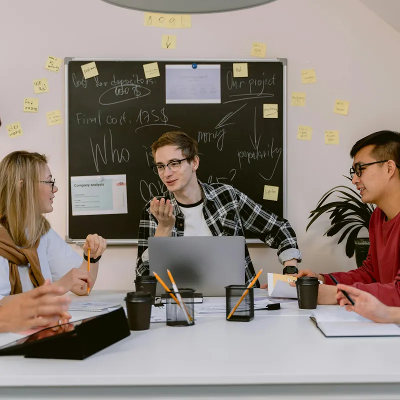 A group of young people having a creative discussion in office setting A group of young people having a creative discussion in office setting