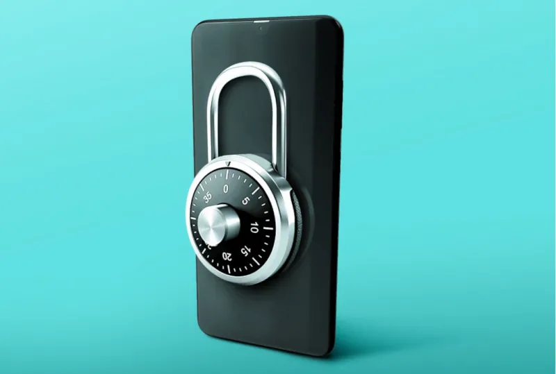  circular silver safety lock attached to a black phone