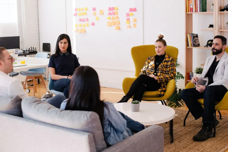 people sat in a relaxed meeting room setting 