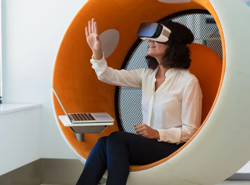 a-woman-wearing-a-VR-in-round-orange-chair