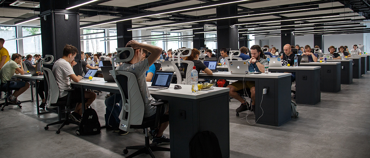 big team of internal developers at a large agency working at their desks