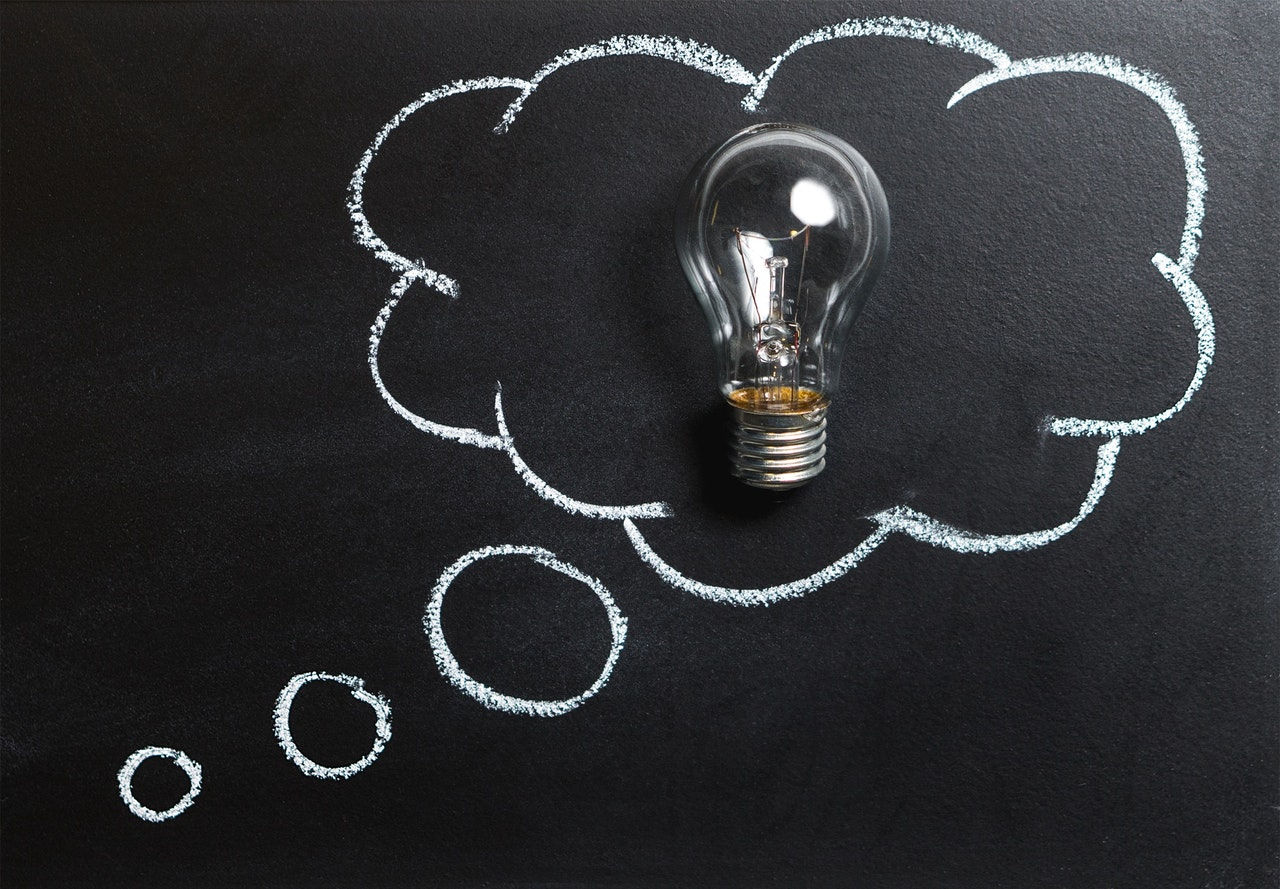 lightbulb in a white chalk cloud on blackboard 