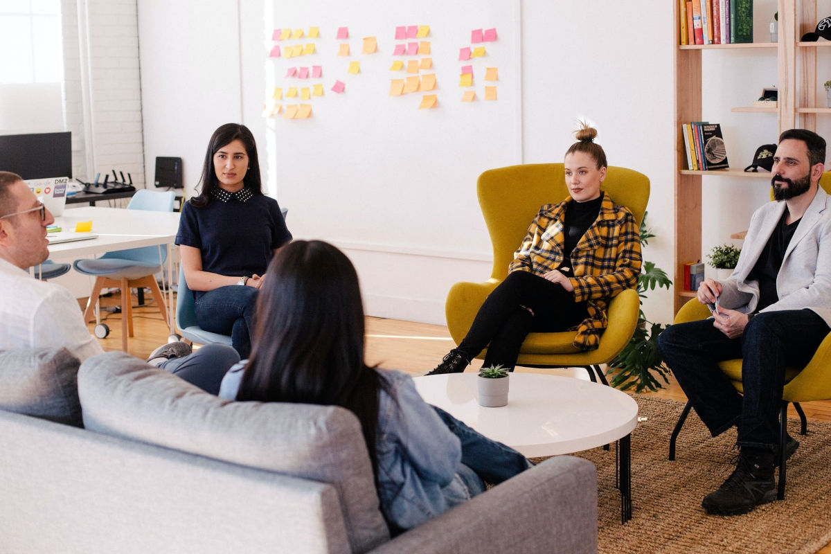 people sat in a relaxed meeting room setting 