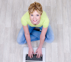 a happy young lady on a laptop